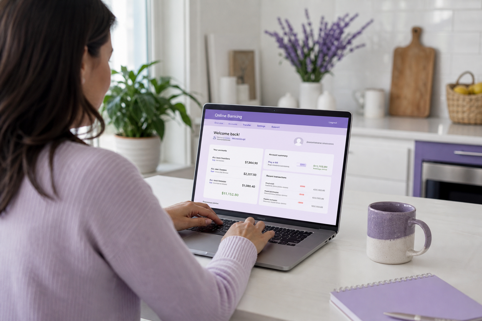 Person using Truist online banking on a laptop in a bright kitchen